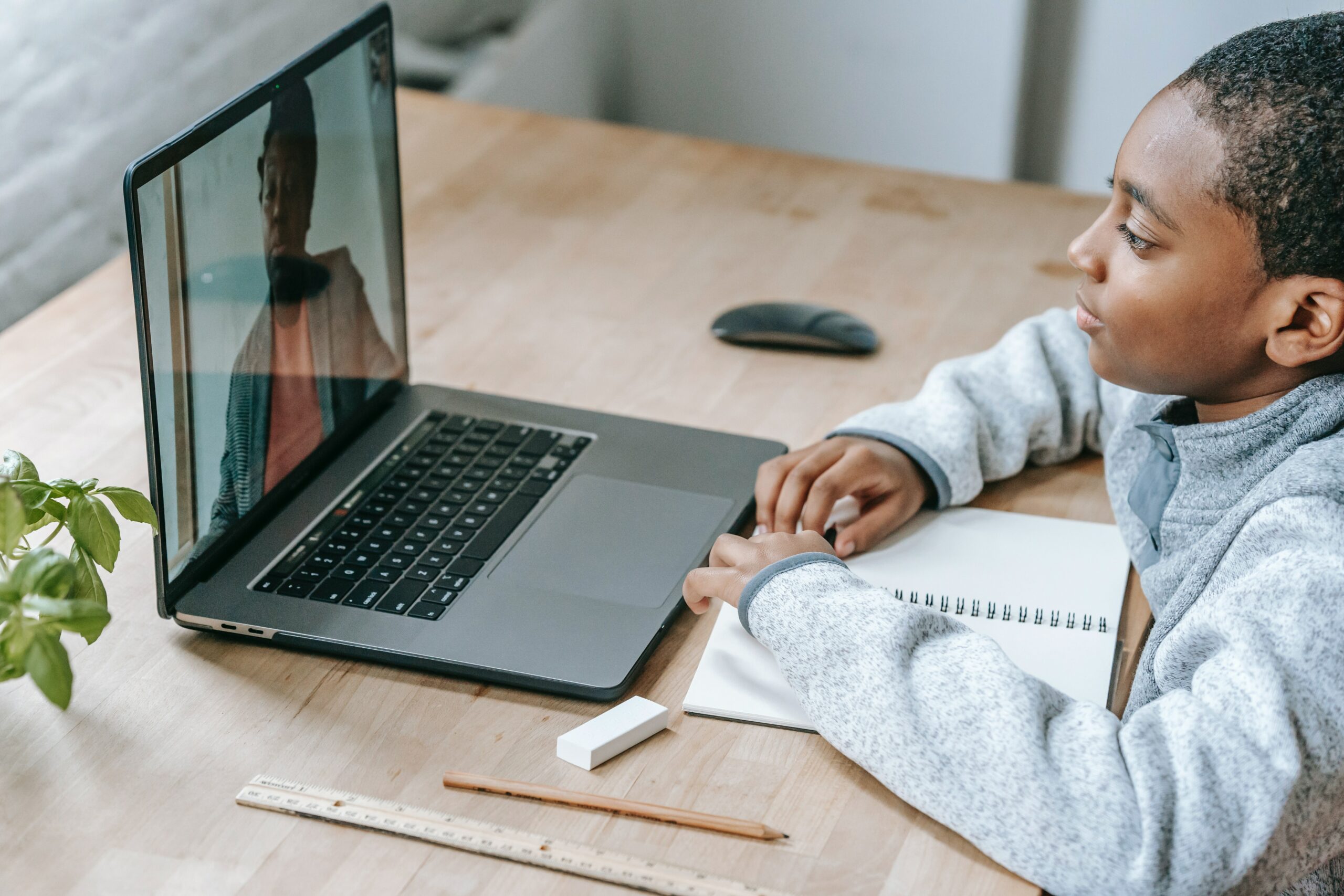 student-listening-to-teacher-on-laptop